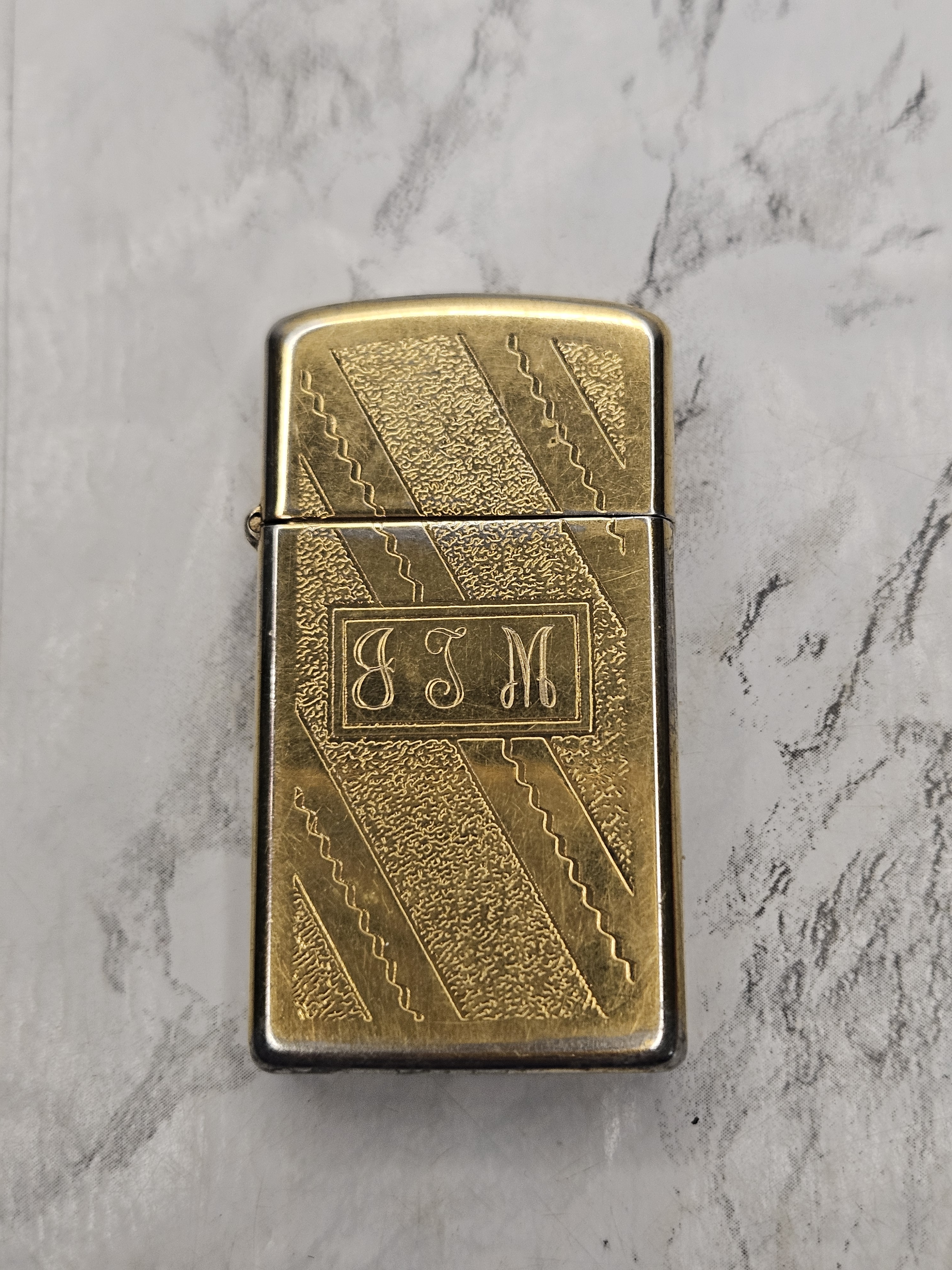 Vintage Zippo Lighter Featuring A Diagonal Striped Design In A Gold Finish